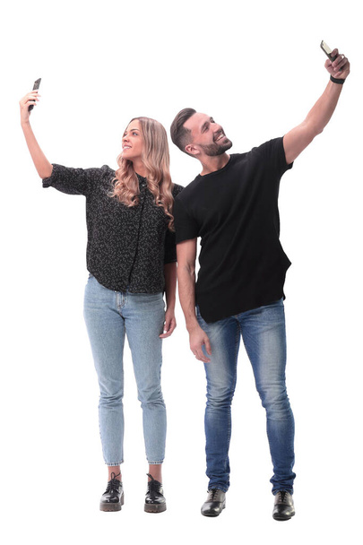 in full growth. smiling young couple taking selfie - Φωτογραφία, εικόνα