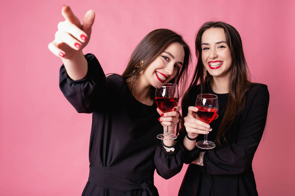 Дві жінки святкують новорічну вечірку, розважаючись і п "ючи вино.. - Фото, зображення