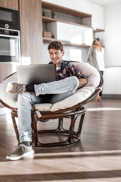 young man uses a laptop in his modern apartment. - Foto, imagen