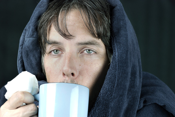 Hombre enfermo con tejido bebiendo de la taza
 - Foto, imagen