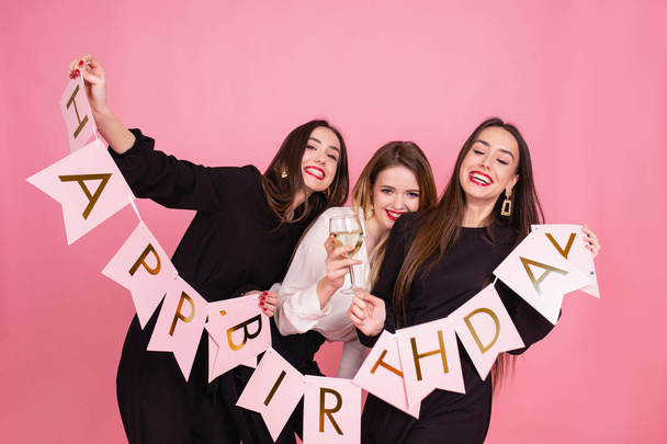 Τρεις όμορφες κομψές γυναίκες γιορτάζουν γενέθλια κόμμα και πίνοντας κοκτέιλ. - Φωτογραφία, εικόνα