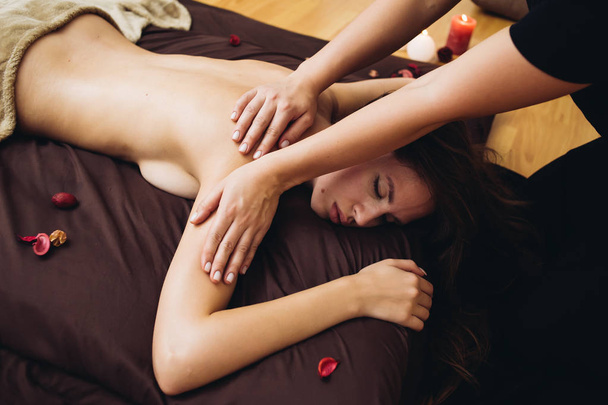 Sensual tantric massage in the cozy atmosphere of a beauty salon by a professional massage therapist - Zdjęcie, obraz