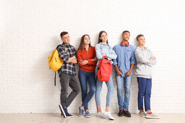 Portrait of teenagers near white brick wall - Foto, Imagen