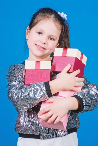 Small girl with present box. Cheerful child. Little girl with gift. Surprise. Childrens day. Congratulation. Happy birthday. Holiday celebration. Boxing day. Christmas shopping. present box - Фото, изображение
