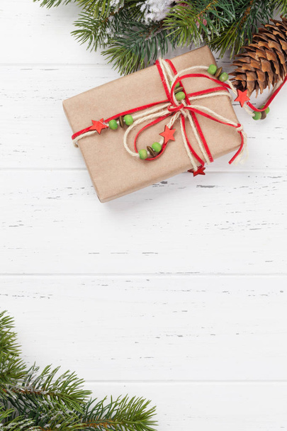Christmas card with gift box and fir tree branch - Fotó, kép