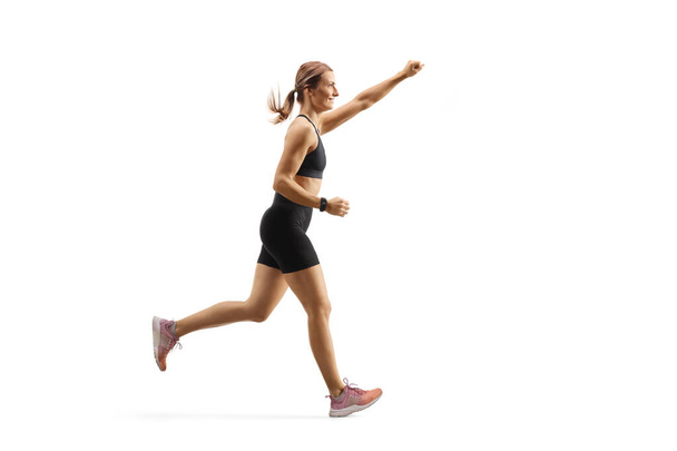 Fit young woman running with raised arm - Foto, Imagem