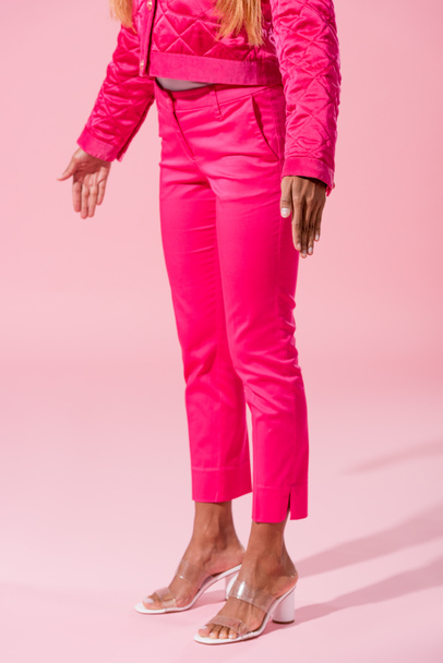 cropped view of trendy african american woman standing on pink background, fashion doll concept - 写真・画像