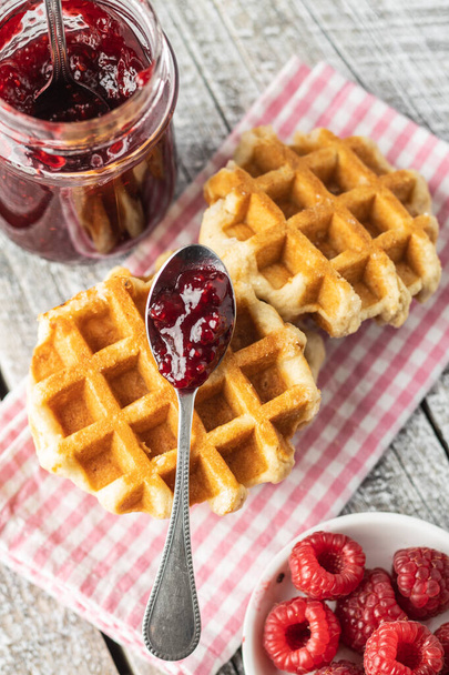 Tasty sweet waffles with raspberries and jam. - Foto, Imagen