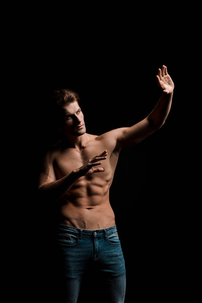 handsome shirtless man posing isolated on black - Фото, изображение