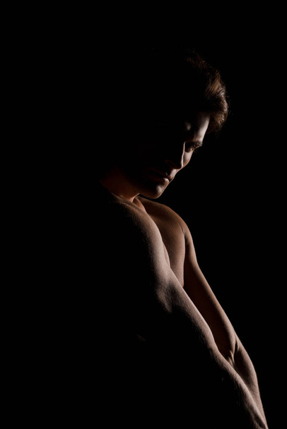 handsome muscular man posing isolated on black - 写真・画像