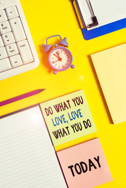 Conceptual hand writing showing Do What You Love Love What You Do. Business photo text Pursue your dreams or passions in life Crumpled white paper on table clock mobile and pc keyboard. - Photo, Image