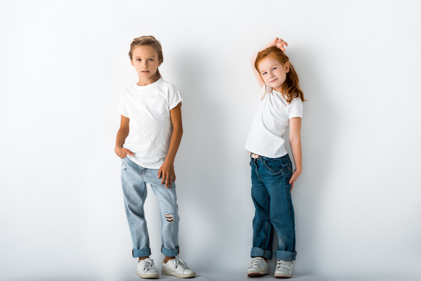 cute kids in denim jeans standing on white  - Fotografie, Obrázek