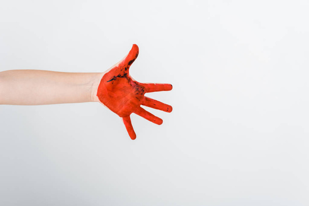 cropped view of kid with red paint on hand isolated on white  - Foto, afbeelding