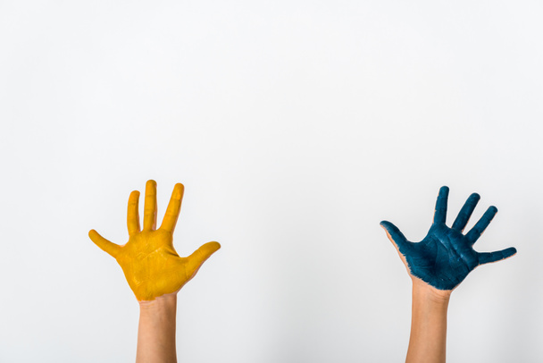 cropped view of kid with blue and yellow paint on hands isolated on white  - Фото, зображення