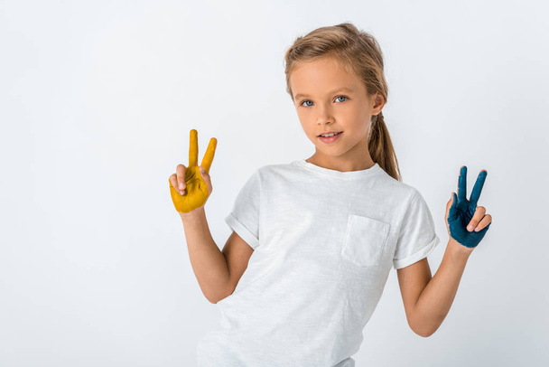 cheerful kid with paint on hands showing peace sign isolated on white  - Fotó, kép