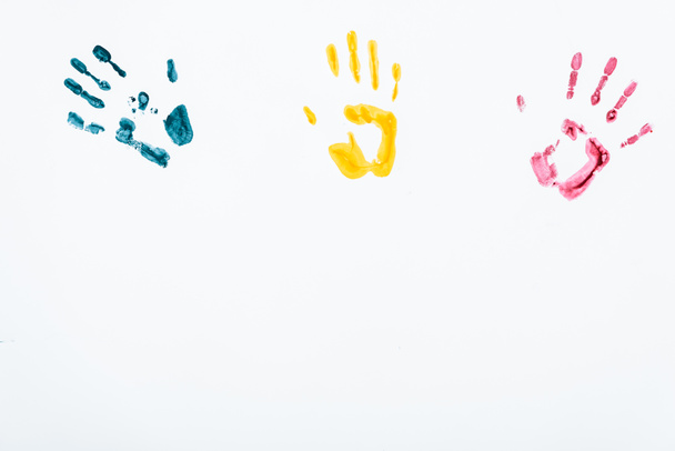 blue, yellow and red hand prints on white  - Fotó, kép
