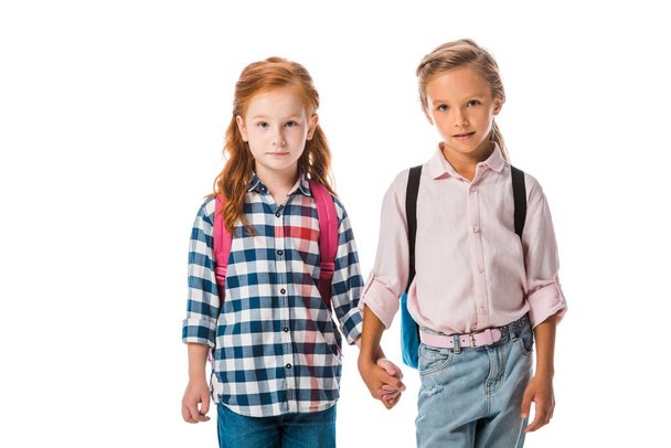 cute schoolkids with backpack holding hands isolated on white  - Photo, Image