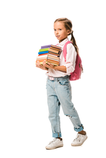 lindo colegial sosteniendo coloridos libros mientras camina aislado en blanco
  - Foto, Imagen