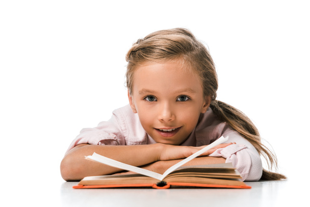 cute and happy kid smiling near book on white  - Foto, Imagem