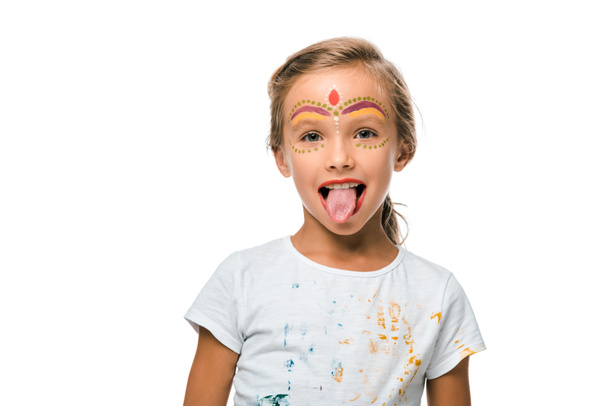 positive kid with face painting sticking put tongue isolated on white  - Photo, Image