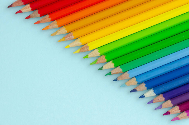Colored pencils composition on blue background. Flat lay. - Fotografie, Obrázek