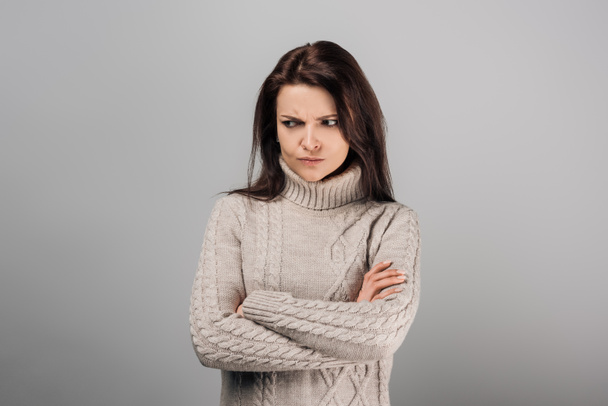 offended woman standing with crossed arms isolated on grey  - Foto, Bild