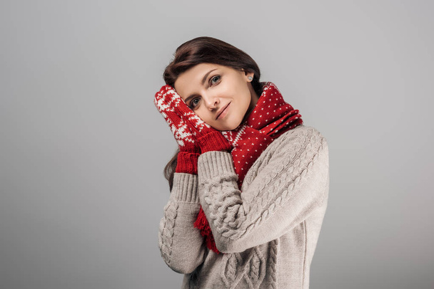 happy woman in red gloves and scarf isolated on grey  - Fotó, kép