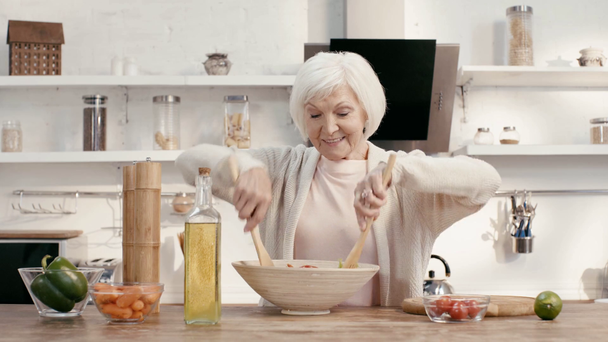 mujer sonriente mezclando ensalada en Acción de Gracias
  - Imágenes, Vídeo