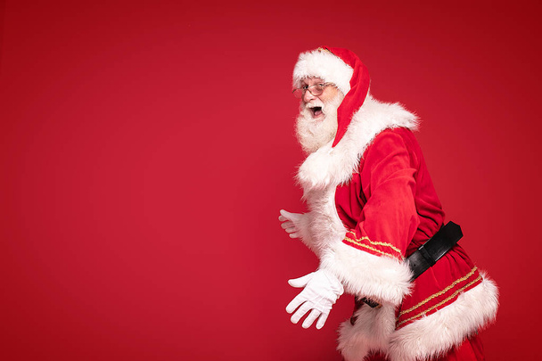 Happy Santa Claus on red studio background. - Valokuva, kuva