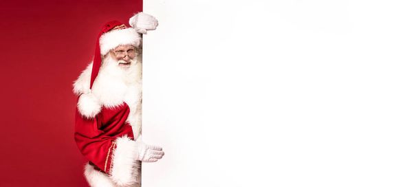 Real Santa Claus holding white empty board. - Photo, Image