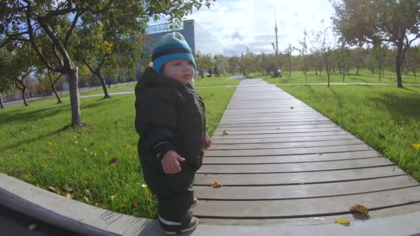 Infant boy on a wooden walkway - Кадри, відео