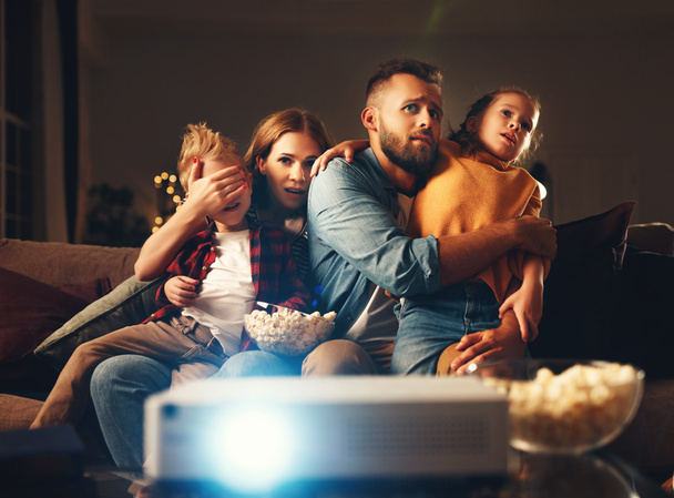 familie moeder vader en kinderen kijken naar projector, TV, films - Foto, afbeelding