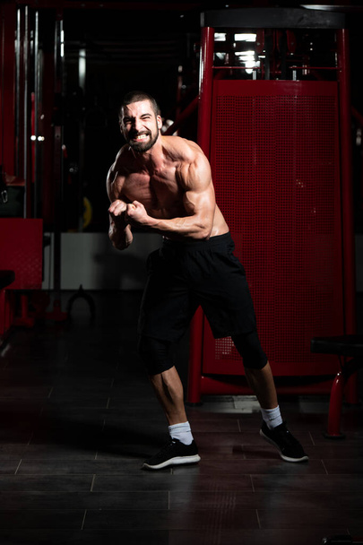 Healthy Young Man Flexing Muscles - Foto, immagini