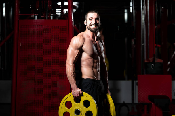 Bodybuilder Holding Weights In Hand - Foto, Imagem