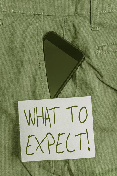 Word writing text What To Expect. Business concept for asking about regard something as likely to happen occur Smartphone device inside formal work trousers front pocket near note paper. - Photo, Image