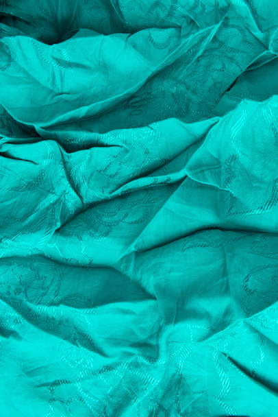 πολύχρωμο κλωστοϋφαντουργίας από κοντά στο φωτεινό πράσινο-μπλέ - Φωτογραφία, εικόνα