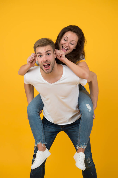 Going crazy together. Woman and handsome man crazy mood. Couple crazy in love having fun. Feeling free and crazy. Young people. Family time. Piggybacking girlfriend. Cheerful mood. Positive emotions - Foto, Bild
