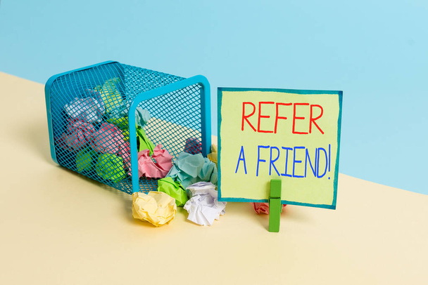 Conceptual hand writing showing Refer A Friend. Business photo showcasing direct someone to another or send him something like gift Trash bin crumpled paper clothespin reminder office supplies. - Foto, immagini