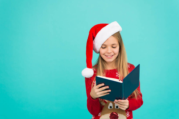 Christmas stories. Little reader copy space. Magic xmas spirit. Best Christmas book. Books store commercial. Little smiling child read book. Christmas eve. Little girl enjoy reading Christmas story - Foto, immagini