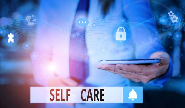 Text sign showing Self Care. Conceptual photo the practice of taking action to improve one s is own health Picture photo system network scheme modern technology smart device. - Photo, Image