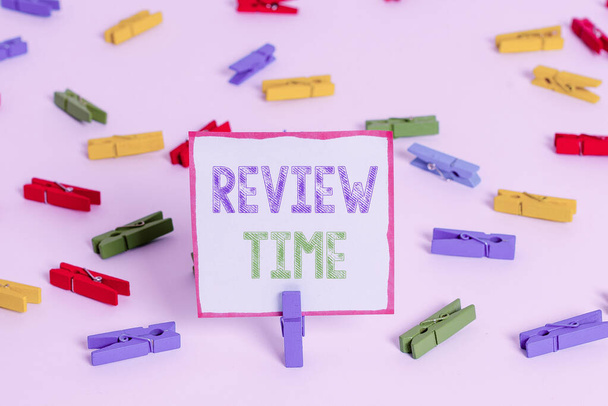 Word writing text Review Time. Business concept for to think or talk about something again Set schedule to review Colored clothespin papers empty reminder white floor background office. - Photo, Image