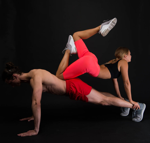 Sporty family. Couple workout. Exercises for muscles. Personal instructor in gym. Clothes for workout training. Feeling support. Sportsman push ups workout with fit girl on back. Couple loving sport - Photo, Image