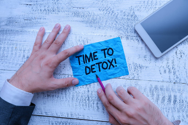 Text sign showing Time To Detox. Conceptual photo when you purify your body of toxins or stop consuming drug Hand hold note paper near writing equipment and modern smartphone device. - Photo, Image