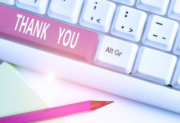 Text sign showing Thank You. Conceptual photo a polite expression used when acknowledging a gift or service White pc keyboard with empty note paper above white background key copy space. - Photo, Image