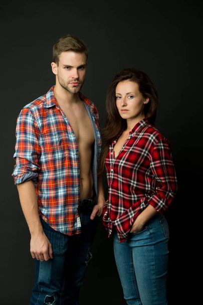 Family look. Similar outfits. Couple wear checkered shirts. Rustic hipster style. Handsome man and woman looking similar in family style clothes. Casual and comfortable. Family posing photo session - Foto, Imagem