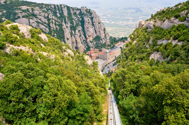 Aerial view of the Montserrat monastery. Santa Maria de Montserrat is a Benedictine abbey located on the mountain of Montserrat, in Monistrol de Montserrat, in Catalonia, Spain - Φωτογραφία, εικόνα