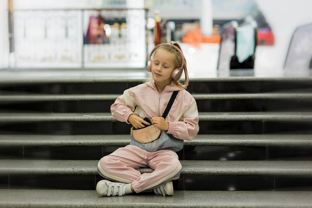 Girl child listen music indoors with modern headphones. Kid litt - Foto, Bild