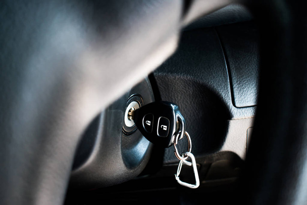 The car key in the keyhole to start the car. Close up. - 写真・画像