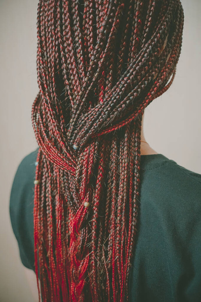 braids African hairstyle on a girl of European appearance, red colored hair, a lot of thin braids - Photo, Image