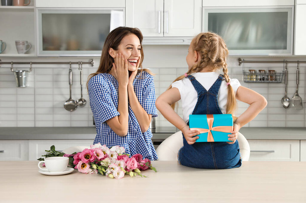 Little daughter congratulating her mom in kitchen. Happy Mother's Day - Fotoğraf, Görsel